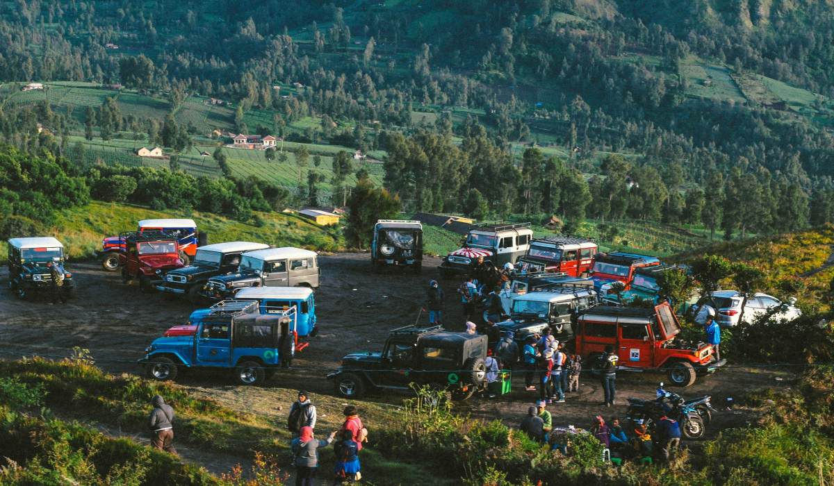 Aerial View of Off-Road Vehicles Gathering in a Mountainous Landscape