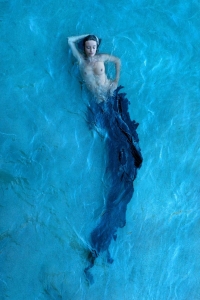 Artistic Serenity: The Mermaid Illusion in Clear Blue Water