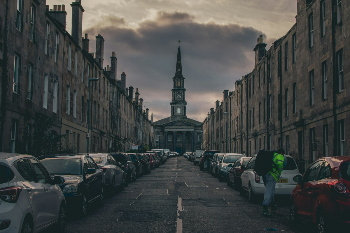 Calm Daytime Scene in a UK Street Packed with Parked Cars