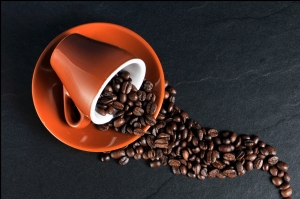 Captivating Coffee Cup Overflowing with Fresh Beans