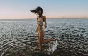Captivating Moments: Woman Splashing Water at Beach