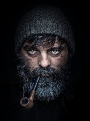 Dramatic Portrait of a Bearded Man with a Pipe