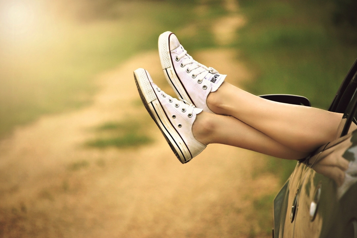 Embracing Nature: A Woman's Relaxing Car Journey on a Dirt Road