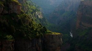 Evening Serenity: A Tranquil River Flowing Through a Rocky Canyon Landscape