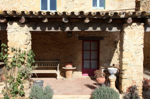 Experience Rustic Charm at a Traditional Catalan Masia: A Scenic Patio in Peratallada, Spain