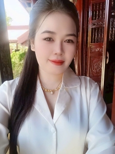 Portrait of a Girl in White Attire Against a Rustic Wooden Background