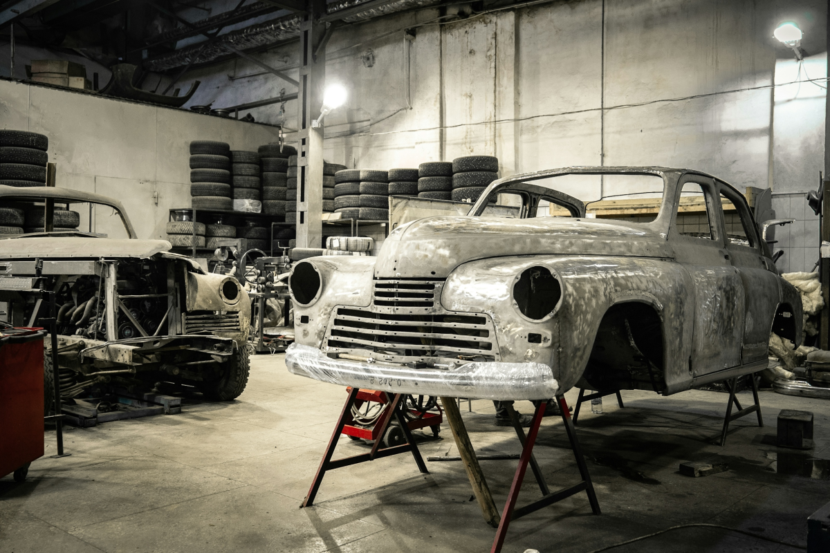 Restoration Journey: White Vintage Car in a Busy Garage Workshop