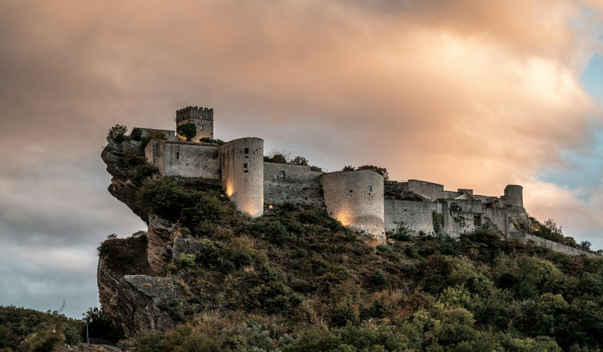 Roccascalegna: An Illuminated Fortress Amidst Gray Clouds in Italy