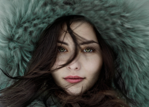 Serenity in Winter: Portrait of a Woman Wearing a Fur Hoodie