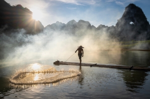 Sunlit Serenity: A Vietnamese Fisherman's Riverside Retreat