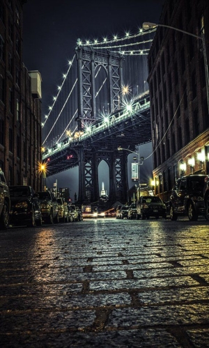 The Manhattan Bridge Illuminated: A Nighttime Jewel in Urban Atmosphere
